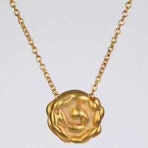 The humility rosette 14K yellow gold necklace with a gold pendant that is shaped like a rose. This 14kdesigner gold necklace is handmade with love in NYC and is sold on ezzykaia’s online fine jewelry store