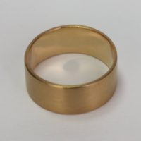 A product photograph overview of a ¼” wide solid yellow gold 14K ring. This gold handcrafted classic band ring is designed by ezzykaia and can be seen on the new online shopping fine jewelry store.