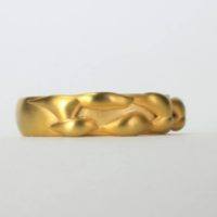 Front view of an 18k yellow gold pinky ring with an unusual 18KT gold detail on the band of the ring. This fine jewelry collection is locally made in NYC by Ezzykaia.com