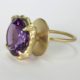 left side of the lollipop 18K green gold ring adorned with a usual ring basket and large 16.68cts amethyst gemstone ring. This amethyst cocktail ring with green 18k gold is locally handmade by the fine jewelry designer Ezzykaia